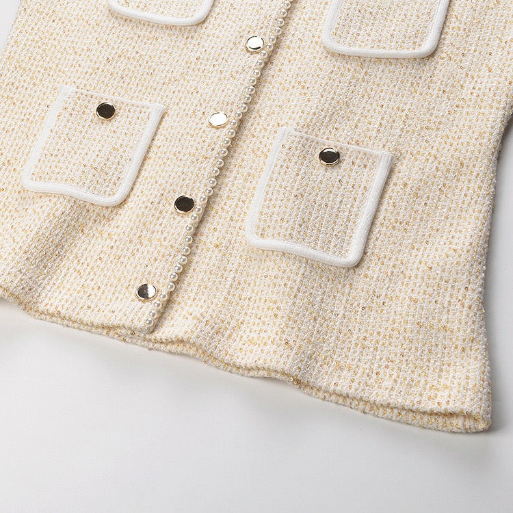 Beige textured fabric with square buttons on a light gray background