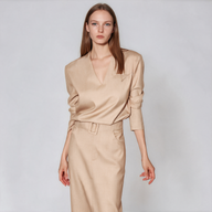 Oatmeal beige workwear set with a V-neck long-sleeve top and high-waisted belted midi pencil skirt, styled for professional women.