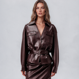 Burgundy leather jacket with a belted waist and point collar, worn with a matching draped lace-trim midi skirt, a women’s two-piece set by Eysè.