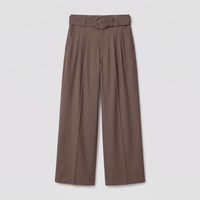 A pair of high-waisted, wide-leg trousers in a muted taupe-brown color, featuring a matching belt with a round metal buckle, displayed against a light gray background.