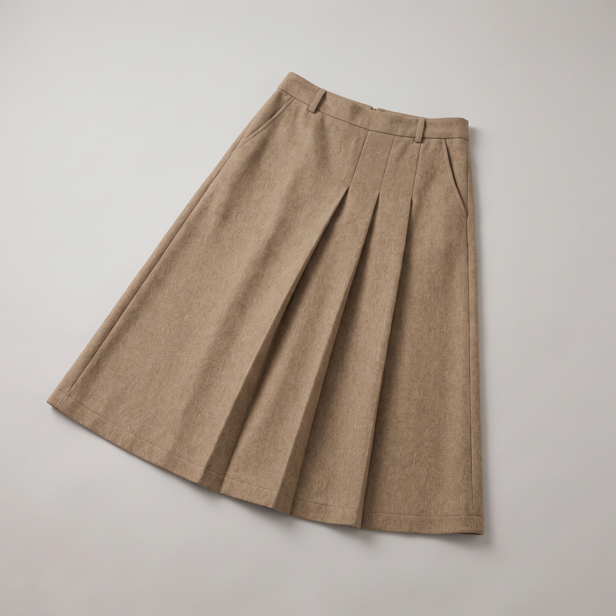 A beige pleated A-line skirt with side pockets, laid flat on a light gray background.