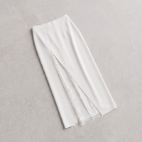 A white midi skirt with a front slit revealing a white lace lining, laid flat on a textured light gray background.