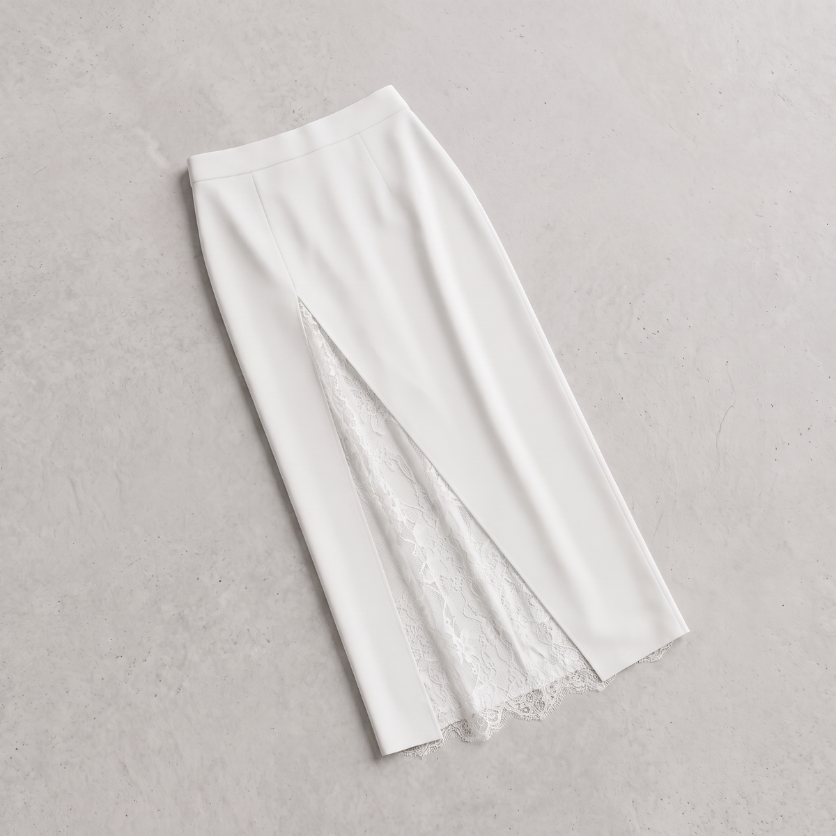 A white midi skirt with a front slit revealing a white lace lining, laid flat on a textured light gray background.