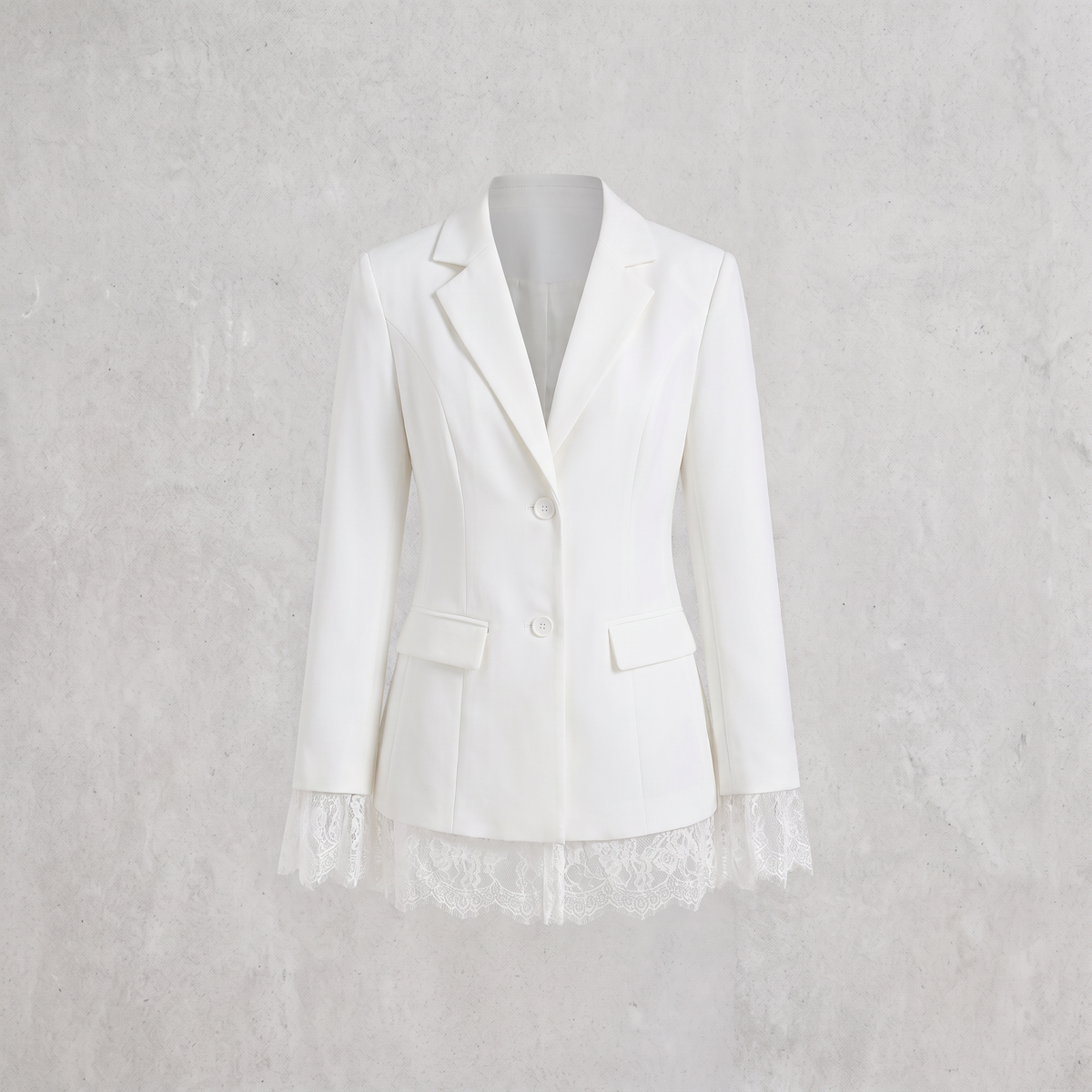 A white tailored blazer with notched lapels, two front buttons, flap pockets, and lace trim at the cuffs and hem, displayed on a mannequin against a light textured wall.