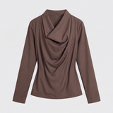 A women's long-sleeve top in a solid medium brown color, featuring a draped cowl neckline, shown against a light gray background.